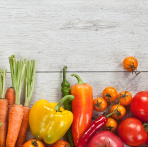 Various vegetables on a table including carrots and peppers